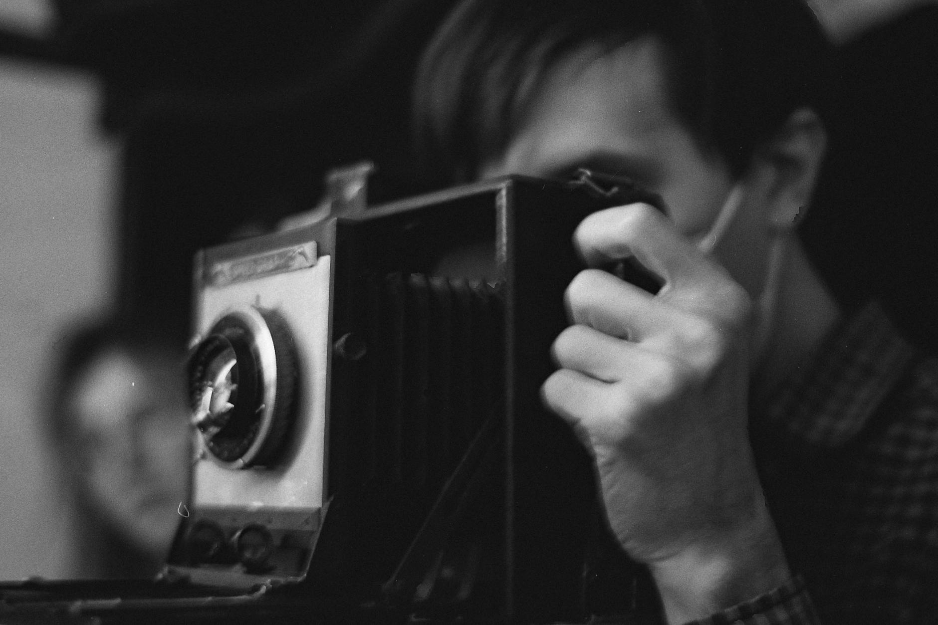 Photo by Дмитрий Пропадалин on <a href="https://www.pexels.com/photo/grayscale-photo-of-a-photographer-using-vintage-camera-10479498/" rel="nofollow">Pexels.com</a>