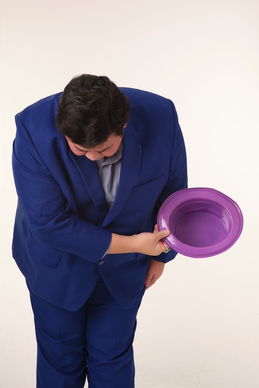 Photo by Wasin Pirom on <a href="https://www.pexels.com/photo/man-bowing-in-blue-suit-holding-purple-hat-31580287/" rel="nofollow">Pexels.com</a>